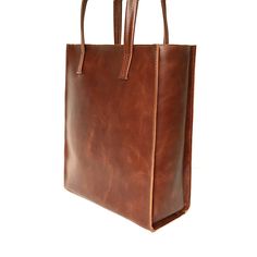 "Tote bag from SHleatnerBags keeps up with the times. The bag has clear lines and holds its shape well. At the same time, the bag is very roomy. Inside the bag there is a pocket with a zipper for small things. Dimensions: Small bag: Height: 11.81\" (30 cm) Width: 9.84\" (25 cm) Depth: 3.15\" (8 cm) Medium bag: Height: 13\" (33 cm) Width: 11.42\" (29 cm) Depth: 3.54\" (9 cm) Large bag: Height: 11.78\" (35 cm) Width: 11.81\" (30 cm) Depth: 5.12\" (13 cm)" Square Travel Bag With Leather Lining, Travel Bags With Leather Lining And Square Shape, Square Leather Bag For Shopping, Leather Rectangular Satchel For Shopping, Classic Rectangular Box Bag For Everyday Use, Rectangular Soft Leather Shoulder Bag For Shopping, Classic Square Box Bag With Leather Handles, Square Business Bags With Leather Handles, Modern Large Capacity Satchel For Gift