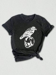 Introducing our Crow On Skull Shirt, the perfect Halloween apparel for those who love a touch of humor. This funny skull t-shirt features a unique design of a crow perched on a skull, making it a standout piece for any Halloween celebration. It's the ideal Halloween gift for friends or family who appreciate a bit of spooky fun. Get ready to turn heads and embrace the Halloween spirit with our Crow On Skull Shirt.

Not just for Halloween, this coffee shirt is a year-round statement piece for all the coffee enthusiasts out there. The combination of the coffee cup and Halloween elements gives it a unique charm that can be worn anytime, anywhere. It's the perfect way to express your love for both coffee and the hauntingly delightful season of witches and ghouls. ☕️ Designed with love and atten Gothic Short Sleeve T-shirt With Skull Print, Gothic Short Sleeve T-shirt For Halloween, Gothic Cotton Top With Skull Print, Casual Skull Print T-shirt For Halloween, Halloween Skull Cotton Shirt, Halloween Skull Print Crew Neck Shirt, Gothic Halloween Skull Print Tops, Gothic Skull Print Crew Neck Top, Gothic Skull Print Tops For Halloween