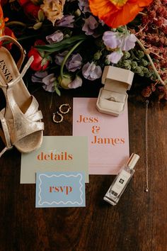 wedding details and shoes on a table with flowers