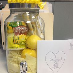 a jar filled with lemons and cheese next to a note that says congratulations on it