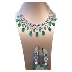 An exceptional Art Deco style parure, complete with earrings and necklace, so stunning and refined , a very piece of art. Necklace come in 18k gold with natural emeralds from Zambia, extra fine quality, in cabochon cut , Ceo Minor, of 91,85 carats, and 640 pieces of natural diamonds of 8,52 carats, F color and VS clarity. Earrings come in 18k gold with 4 pieces of natural emeralds from Zambia, extra fine quality ,Ceo Minor , of 26,76 carats, and 140 pieces of natural diamonds of 1,96 carats, rou Luxury Emerald Jewelry For Formal Occasions, Exquisite Hand-set Emerald Necklace For Formal Occasions, Formal Emerald Necklace With Diamond Cut, Formal White Gold Emerald Necklace, Formal Emerald Necklace With Elegant Design, White Gold Diamond Jewelry Set With Matching Earrings, Exquisite Emerald Necklace With Elegant Design For Formal Events, Fine Jewelry Sets In White Gold For Formal Occasions, Formal White Gold Jewelry Sets With Diamond Cut