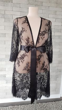 Black luxurious wedding robe, to add a perfect touch to your perfect and unique day. It can be made of high quality satin called Italian silk or natural silk. Only high quality fabrics and high finishing used for making the robe as neat as it can be. Please find the wedding robes collection here https://www.etsy.com/shop/LidiasBoutiqueDesign?ref=seller-platform-mcnav&section_id=25023222. For wedding dresses, please access https://www.etsy.com/shop/LidiasBoutiqueDesign?ref=seller-platform-mcn Elegant Wrap Sleepwear, Elegant Lace Sleepwear, Fitted Lace Wedding Robe, Chic Lace Gown, Elegant Robe With Lace Sleeves For Wedding Night, Fitted Lace Robe For Wedding Night, Elegant Fitted Wrap Robe, Feminine Lace Wedding Robe, Elegant Long Sleeve Bridesmaid Sleepwear