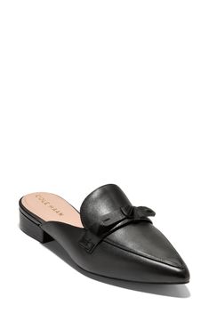 A dainty bow adds a dose of sweetness to a refined mule elongated by a pointy toe. 1" heel Leather upper/synthetic lining/rubber sole Imported Elegant Flat Mules For Evening, Formal Slip-on Heels With Bow, Elegant Flat Mules With Leather Sole, Elegant Flat Heel Mules For Office, Elegant Slip-on Synthetic Mules, Formal Low Heel Synthetic Mules, Chic Pointed Toe Mules With Bow, Classic Flat Mules For Formal Occasions, Elegant Pointed Toe Mules With Bow