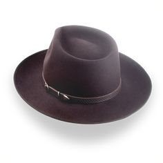 Description Materials Craftsmanship Hat Care Shipping Returns Product Description A Stylish and Functional Men's Western Fedora Elevate your rustic style with the Ulysses, a men's western fedora handcrafted from luxurious rabbit fur felt. Featuring a smooth finish and a distinctive teardrop crown, this hat combines classic western flair with modern sophistication. With a 4 3/4" crown height and a 2 7/8" ribbon-bound snap brim, the Ulysses strikes the perfect balance between style and functionali 1940 Style, Outdoor Hut, Hats For Big Heads, The Raid, Mens Western, Homburg, Crown Design, Leather Hats, Chocolate Color