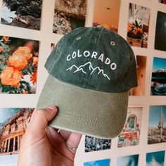 a person holding up a hat with the word colorado on it in front of many pictures