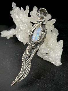 "Beautiful and Unique Moonstone Feather Pendant with .925 Sterling Silver handmade by a Mexican master artisan in the land of Guadalajara, Jalisco, Mexico. A beautiful Jewelry Statement Piece. It comes with a Silver Chain. Size: 3.5\" x 0.7\" x 0.27\" (9.0 x 1.8 x 0.7 cm) 15 gr. The symbolism of feathers signifies honor and a connection between the owner, the Creator, and the animal kingdom, It symbolizes trust, honor, strength, wisdom, power, and freedom. It is an object that is deeply revered