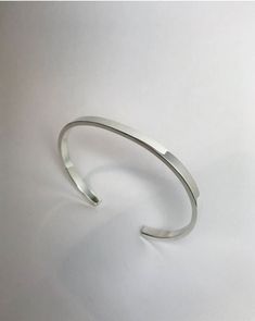 Plain and simple- We think it's just a good idea to keep one of these in your jewelry box. Great for layering or a beautiful stand alone piece for a modern look. Polished to perfection. Available matte or oxidized if you prefer.  *Sterling Silver  *4mm wide  *2mm thick *One size fits most Modern Sterling Silver Cuff Bracelet Bangle, Modern Sterling Silver Cuff Bracelet With Polished Finish, Modern Sterling Silver Open Cuff Bangle, Minimalist Silver Open Cuff Jewelry, Minimalist Cuff Bangle With Polished Finish, Classic Open Band Bangle As Gift, Modern Cuff Jewelry For Everyday, Minimalist Adjustable Bangle With Polished Finish, Adjustable Minimalist Bangle With Polished Finish