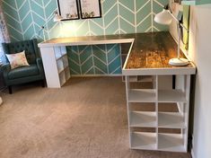 a room with a desk, chair and shelves on the floor in front of it