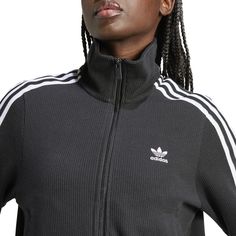 Taking your style back to a simpler time is never the wrong move. And the adidas Firebird Knitted Pinstipe Women's Track Jacket is the perfect example. Besides its classic look brought into the 21st century, this jacket also touts comfort and is easy to match with sweats, jeans, or even a pair of chinos.Regular, relaxed fit. Zip-up. Features adidas three-stripe design. Ribbed hem and cuffs. Has two zippered, front pockets. Fabric: 100% Polyester. Made from 100% recycled materials. Casual Track Jacket With Side Stripes For Fall, Fall Casual Track Jacket With Side Stripes, Casual Winter Outerwear With Side Stripes, Casual Winter Track Jacket With Side Stripes, Adidas Outerwear With Side Stripes For Fall, Sporty Ribbed Outerwear For Fall, Casual Black Outerwear With Side Stripes, Casual Three Stripes Outerwear For Fall, Casual Three Stripes Fall Outerwear