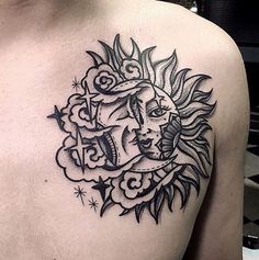 a man with a sun and moon tattoo on his chest