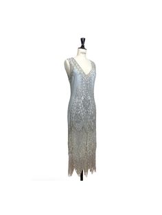 The epitome of Art Deco design...our Icon Gown is positively decadent! With a deep v neckline, the Icon features front and back panels accented with a sparkling floral design. The gown is finished with a scalloped hem dripping with beaded fringe.  It is the classic flapper look for a modern woman. The Icon is one of our best selling dresses for a reason! Cutout design on the upper back. Full-Length.  Matching slip included. Sbust 33-35", waist 29-31", hips 38-40", length 50" Mbust 36-38", waist Gatsby Style V-neck Evening Dress, Embellished Fitted V-neck Flapper Dress, Vintage V-neck Wedding Dress, Vintage V-neck Flapper Dress For Evening, Elegant Floor-length Flapper Dress For Gala, Vintage V-neck Evening Dress For Formal Occasions, Vintage V-neck Evening Dress, Sequined V-neck Wedding Gown, V-neck Sequin Wedding Gown