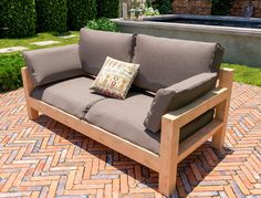 a couch sitting on top of a brick patio