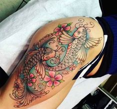 a woman's thigh with a tattoo design on it