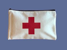 "Be prepared for minor physical disasters with this First Aid Bag. Vinyl Red Cross on Black or Beige Canvas Zippered Pouch ✔️ choose a black or beige zippered pouch. 📏 ~ 8\" x 5\" ⛑ Free Shipping in Canada!  🇨🇦 Free Shipping in USA when you spend $35 USD or more  ⌨️ Message me directly for custom and bulk orders! This bag will arrive empty.  Fill it with all your first aid needs and keep it handy." Portable Red Rectangular Pouch, Red Zipper Pouch Bag, Red Rectangular Pencil Case For Everyday Use, Red Rectangular Travel Pencil Case, Red Rectangular Pencil Case For Travel, Rectangular Red Pencil Case For Travel, Red Rectangular Pencil Case, Red Pouch Cosmetic Bag For Daily Use, Red Cosmetic Pouch For Daily Use