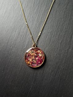 This beautiful necklace is a wonderful idea for gift giving and as a little gift for yourself. The pendant measures approximately 3 cm. Please choose your chain length preference in the drop down box. See more jewellery here: https://www.etsy.com/shop/simplysweetjewellery I'm happy to help you find what you're looking for! Please feel free to message me with any questions. Thank you for shopping at Simply Sweet Jewellery! PLEASE NOTE: Colours may not look the same as on your computer - Avoid any contact with water (shower, pool, sea etc.) - Avoid direct contact with chemicals such as perfume, hairspray & other types of lotion  - Don't use abrasive products to clean your jewellery.  They can damage plating irreparably. - Wear these jewels with love Resin Locket Necklace, Resin Chain Necklace, Bohemian Necklace As Gift For Her, Nature-inspired Necklace With Adjustable Chain For Gift, Nature-inspired Necklace With Adjustable Chain As Gift, Spiritual Pink Charm Necklace As Gift, Spiritual Pink Charm Necklace For Gift, Pink Spiritual Charm Necklace For Gift, Gift Charm Necklace With Round Pendant And Lobster Clasp