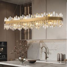 a modern chandelier hanging over a kitchen counter