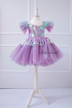 Make your little girl's birthday extra special with this gorgeous  Mermaid Dress! This stunning toddler birthday outfit features a beautiful mermaid-inspired design with a flowing lilac tutu skirt and a mermaid detail. The dress is perfect for any special occasion, including birthdays, cake smashes, and princess-themed parties. Made with high-quality materials, this baby girl tutu dress is soft, comfortable, and breathable, ensuring that your little one stays cozy and stylish all day long. Wheth Toddler Mermaid Dress, Birthday Princess Fairy Dress With Ruffles, Princess Fairy Dress With Ruffles For Birthday, Princess Style Fairy Dress With Ruffles For Birthday, Fitted Mermaid Tutu Dress For Birthday, Pink Mermaid Dress For Pageants, Pink Mermaid Dress With Mermaid Hem For Pageants, Pink Pageant Mermaid Dress With Mermaid Hem, Tulle Mermaid Dress With Ruffles For Pageant