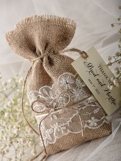 a bag with a tag on it sitting next to some baby's breath flowers