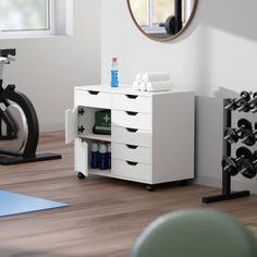 there is a bike and exercise equipment in the room with it's mirror on the wall