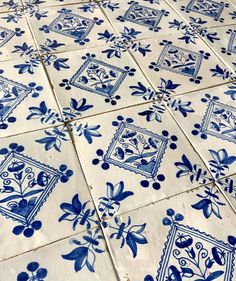 blue and white tiles are arranged on the floor in an ornate pattern, with small flowers