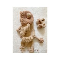 a stuffed animal laying on top of a white rug next to a toy monkey and teddy bear