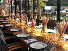 a long table with plates and glasses on it