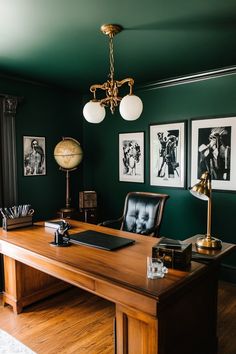 an office with green walls and pictures on the wall, including a leather chair in front of a wooden desk