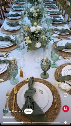 the table is set with plates and place settings