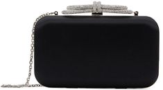 Structured satin clutch in black. · Detachable curb chain shoulder strap · Crystal-cut bow appliqué at clasp · Hinged closure · Grained leather lining · H4.5 x W8 x D2 Supplier color: Black Black Party Clutch With Detachable Strap, Trendy Black Clutch With Detachable Handle, Designer Black Clutch With Detachable Strap, Black Clutch With Detachable Handle, Black Rectangular Clutch With Detachable Handle, Bow Clutch, Satin Clutch, Embellished Clutch, Double Bow