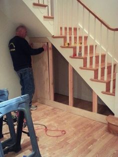 a man is working on some stairs in a house