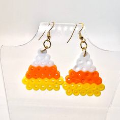 a pair of earrings made out of plastic beads