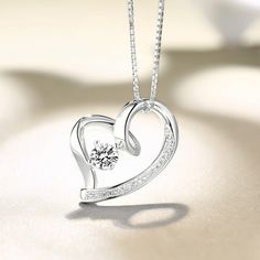 On Valentines Day, there is nothing more meaningful than a heart pendant with a birthstone. It is a truly great gift to express your love to your dearest one. The necklace is made of .925 sterling silver with a gem on the middle which can be personalized with a birthstone of your choosing. The Love In Your Heart Personalized Pendant Necklace arrives with a velvet jeweler's pouch and presentation box, perfect for safekeeping or gift giving. Celebrate the eternal nature of true love with this excl Valentine's Day Diamond White Necklace Gift, Diamond White Necklace For Valentine's Day Gift, Valentine's Day Gift Diamond White Necklace, Silver Birthstone Necklace For Anniversary With Clavicle Chain, Elegant Birthstone Necklace For Anniversary Or Mother's Day, Diamond White Necklace For Valentine's Day Anniversary, Elegant Birthstone Necklace For Mother's Day Anniversary Gift, Elegant White Gold Birthstone Necklace For Mother's Day, Elegant White Gold Heart Pendant Birthstone Necklace