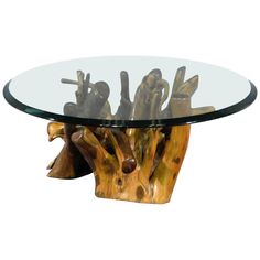 a glass table with wooden carvings on it