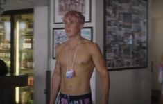 a young man with pink hair and no shirt is standing in front of a refrigerator