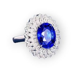 Elevate your style with our exquisite Regal Elegance Ring, featuring a captivating Coneflower Style design:Material: 18K White GoldMain Stone: 5.5 Carats Natural Sapphire Oval CutSide Stone: 148 pieces (1.49 carats) Natural DiamondTotal Weight: 9.76gStyle: Coneflower Style Crafted to perfection, this ring exudes timeless sophistication and unparalleled charm, making it a stunning statement piece for any occasion. Please note that this is a custom order. For sizing inquiries or to place your orde 5 Carat Ring, Regal Elegance, Ring Shapes, Charm Making, Green Diamond, Aquamarine Blue, Sapphire Engagement, Natural Sapphire, Yellow Diamond