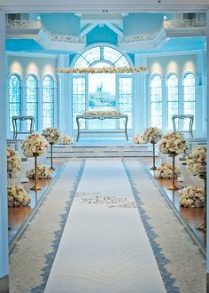 the aisle is decorated with flowers and candles