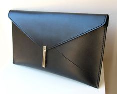 This beautiful leather women's envelope clutch bag is made of black leather. It has a elegant silver color metal closure. Without lining. It is 100 % handmade and designed by me. Main color: Black Material: Black leather Silver color metal closure Measurement: Width 35 cm (~14 inch) Height 20 cm (~8 inch) Please feel free to contact me if you have any questions about this item. Formal Envelope Clutch, Black Envelope Clutch For Office, Black Envelope Clutch For Formal Occasions, Modern Envelope Clutch For Formal Occasions, Elegant Black Envelope Clutch, Modern Leather Envelope Clutch, Modern Envelope Clutch For Office, Leather Envelope Clutch For Office, Leather Envelope Clutch