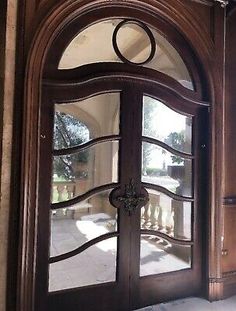 an ornate wooden door with glass panels