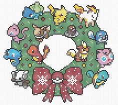 a cross stitch christmas wreath with animals and bows on it's front end, in the shape of a circle