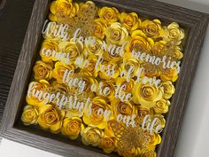 a wooden frame with some yellow flowers and words on the inside that says, i love my memories