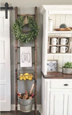 an old wooden ladder is used as a shelf for fruit and vegetables in this kitchen