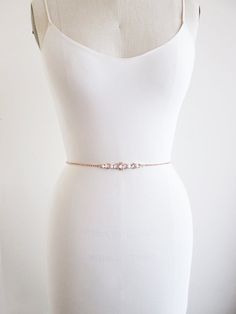 "This sparkly super skinny bridal belt is made with Swarovski crystals beaded on a 1/8\" wide ribbon. The crystal part of the belt measures 26\" long with the center detail measuring 3 1/2\" long. Finished with the 1/4\" satin ribbon ties in the back. The entire sash measures 150\" long. Available in gold, silver or rose gold finish. - For the photo of the ribbon color options, please take a look here: https://www.etsy.com/listing/225025505/satin-ribbon-swatches-ribbon-color?ref=shop_home_active Elegant Evening Belts With Rhinestones, Elegant Rhinestone Bridal Belt For Bridesmaids, Elegant Fitted Bridal Belt, Elegant Silver Bridal Belt For Prom, Elegant Gold Fitted Bridal Belt, Elegant Fitted Gold Bridal Belt, Elegant Evening Bridal Belt With Embroidery, Elegant Embroidered Bridal Belt, Elegant Bridal Belt With Sashes