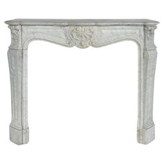 an antique white marble fireplace mantel