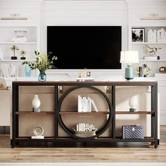 a living room with a large flat screen tv on top of a wooden entertainment center