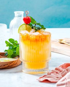 a glass filled with lemonade and garnish on top of a table