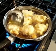 a pan filled with food cooking on top of a stove