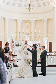 the bride and groom are getting married in front of the alter at their wedding ceremony