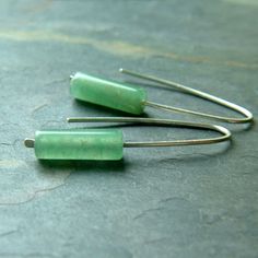 "Sterling silver modern minimalist open hoop dangles. Sterling silver handmade ear wires with mossy green aventurine cylinder beads. The soft green shades of the aventurine combines with the sterling silver for a sleek modern look. These aventurine open hoop earrings are approximately 1 1/4\" long. They come gift boxed and ready for giving (or keeping). ;) To get to my shop's main page: http://www.etsy.com/shop/ArtistiKat Thanks for shopping hand made.. PLEASE read shop policies prior to purchas Aventurine Earrings, Ear Threader, Green Aventurine Stone, Wire Jewelry Tutorial, Unique Jewelry Gifts, Diy Bracelet Designs, Open Hoop Earrings, Earrings Green, Green Gemstones