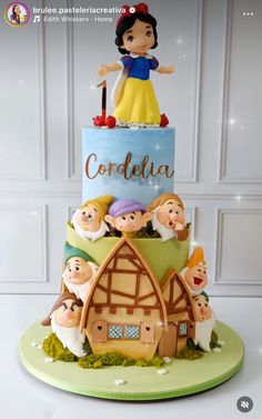 there is a cake that has snow white on top and people around it with the name cordella