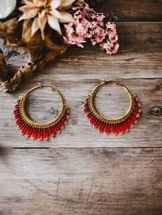 Add a touch of sophistication and color to your look with these beautiful woven beaded hoop earrings. Each pair is meticulously handmade, with an elegant gradient of red shades, ranging from deep red to light red. These earrings are ideal for enhancing an evening outfit or adding a touch of glamor to your everyday style. Diameter of the hoop (interior): 35mm Maintenance tips : Avoid contact with water, perfumes and chemicals to preserve the color and luster of the pearls. Store hoop earrings in Red Festival Hoop Earrings, Red Bohemian Small Hoop Earrings, Red Round Hoop Earrings For Festivals, Bohemian Red Small Hoop Earrings, Elegant Red Handwoven Jewelry, Bohemian Red Hoop Earrings With Colorful Beads, Red Bohemian Adjustable Hoop Earrings, Handmade Red Bohemian Hoop Earrings, Handmade Bohemian Red Hoop Earrings